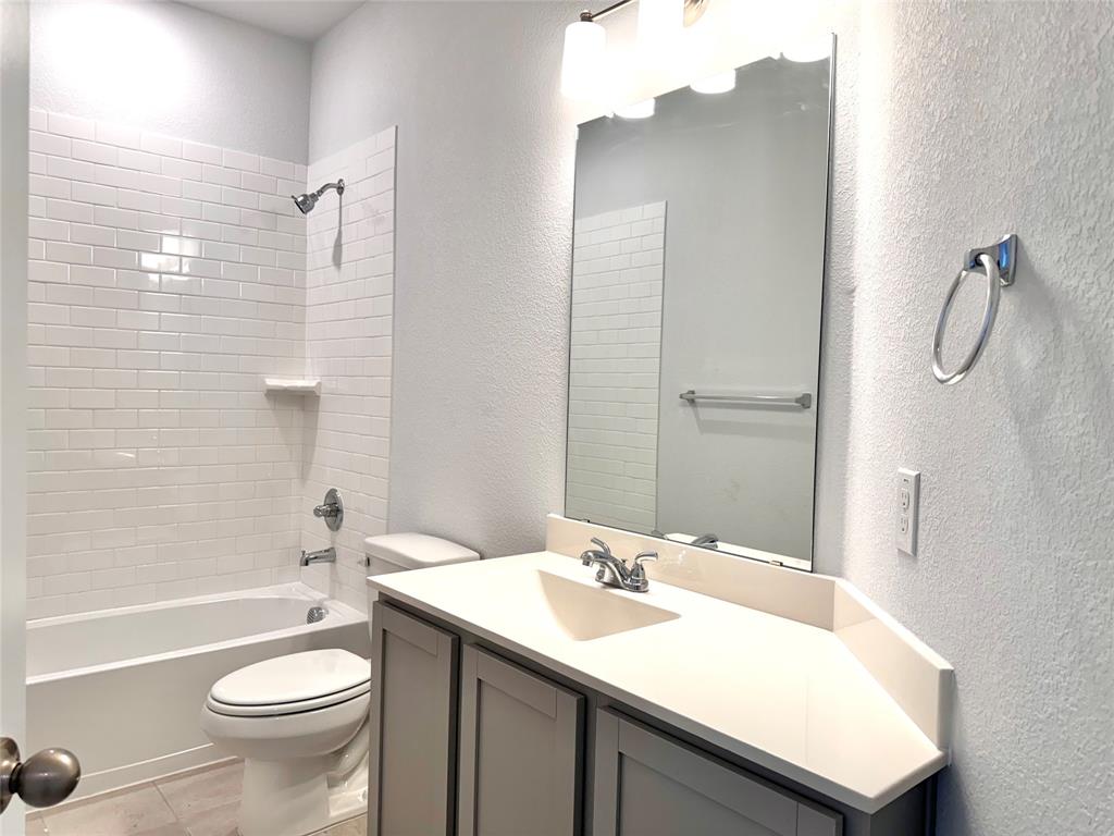 1919 Aleia Cove Sherman, TX 75092 - Photo 27 of 32 a bathroom with a sink toilet and shower