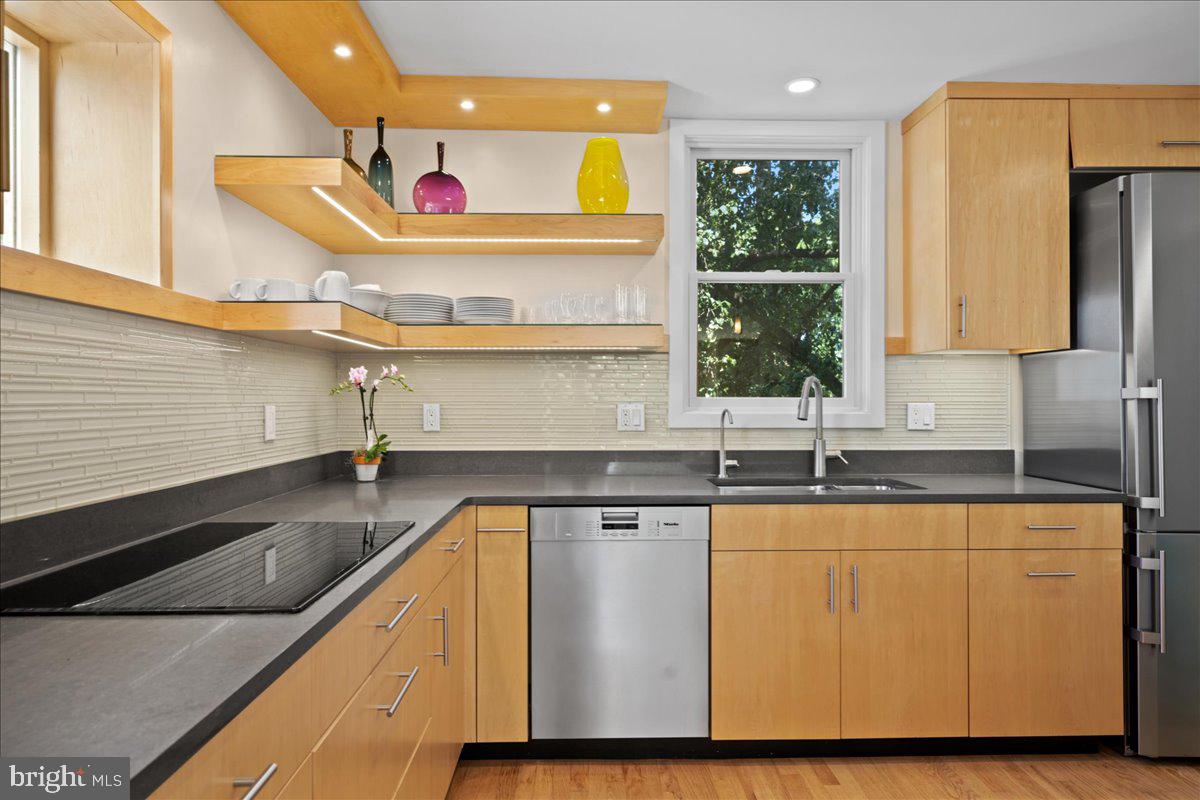 60 Humbert Street Princeton, NJ 08542 - Photo 18 of 44 a kitchen with stainless steel appliances granite countertop a sink a stove and a wooden floor