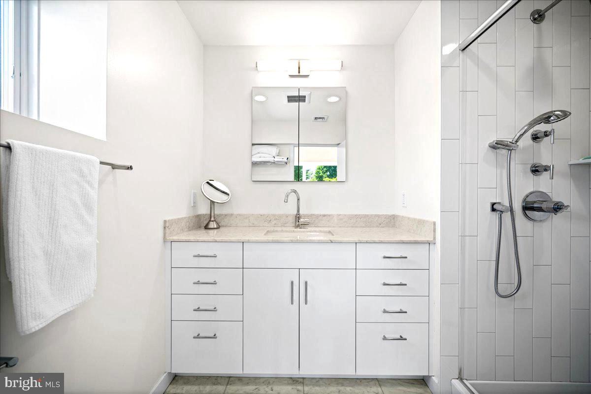 60 Humbert Street Princeton, NJ 08542 - Photo 25 of 44 a bathroom with a granite countertop sink a mirror and shower