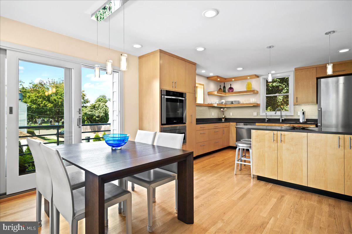 60 Humbert Street Princeton, NJ 08542 - Photo 5 of 44 a kitchen with stainless steel appliances granite countertop wooden floor dining table and chairs