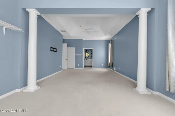 a view of empty room with closet and window