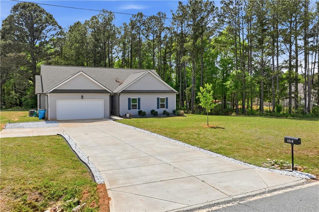 1269 Covered Bridge Road Covington, GA 30016 - Photo 31 of 31 a front view of a house with yard