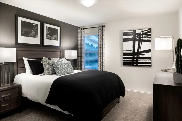 a bedroom with bed and window