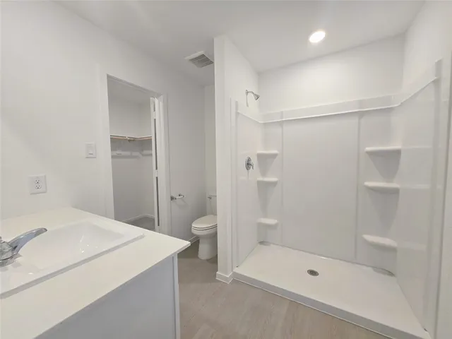 a bathroom with a shower and a sink