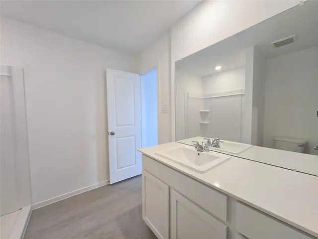 a bathroom with a sink vanity and a mirror