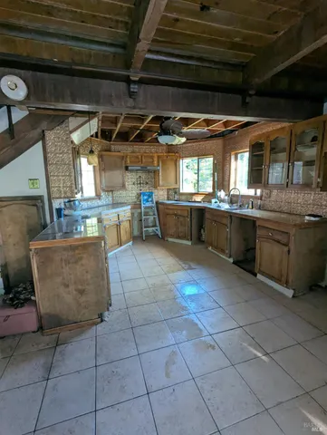 a living room with furniture a flat screen tv and a floor to ceiling window