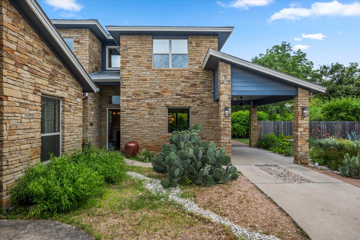 913 Stobaugh Street, Unit B Austin, TX 78757 - Photo 3 of 40 Artfully crafted stone facade welcomes you to a home of distinction, framed by mature trees and verdant landscaping.