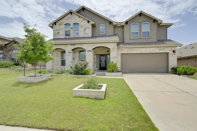 a front view of a house with garden