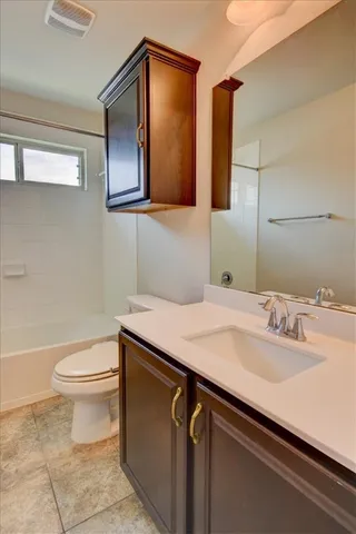 a bathroom with a sink a toilet and mirror