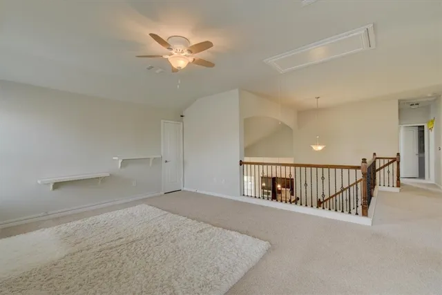a view of a livingroom with a ceiling fan and window