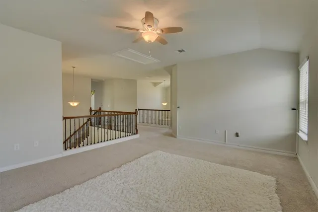 a view of entryway and hall with a chandelier fan