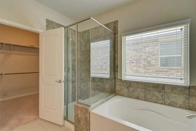 a bathroom with a bathtub and a shower