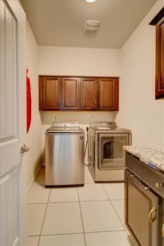 a white kitchen with stove top oven and cabinets