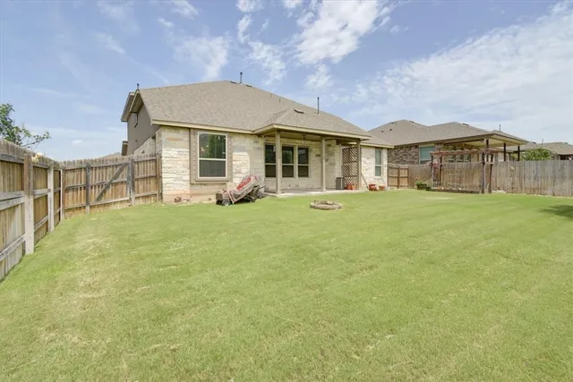 a view of a house with a big yard and large trees