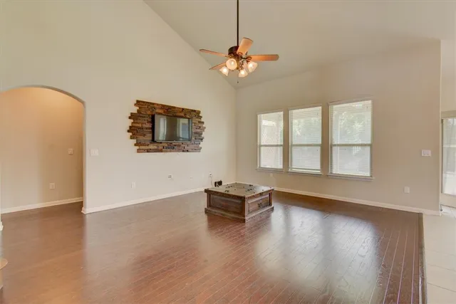 a view of a livingroom with wooden floor and a window