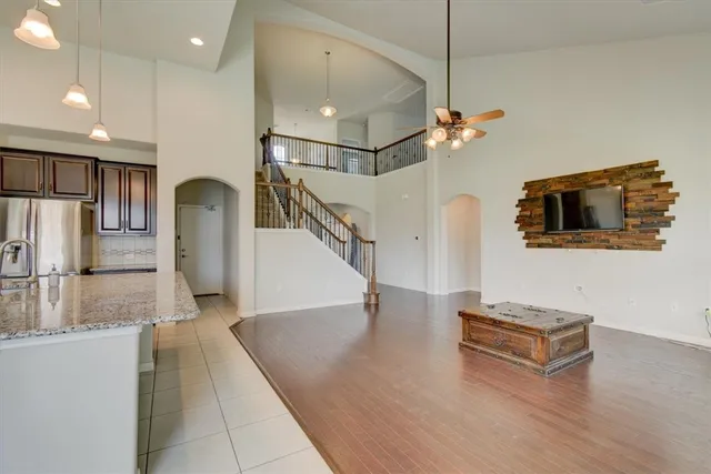 a living room with stainless steel appliances kitchen island granite countertop furniture and a kitchen view