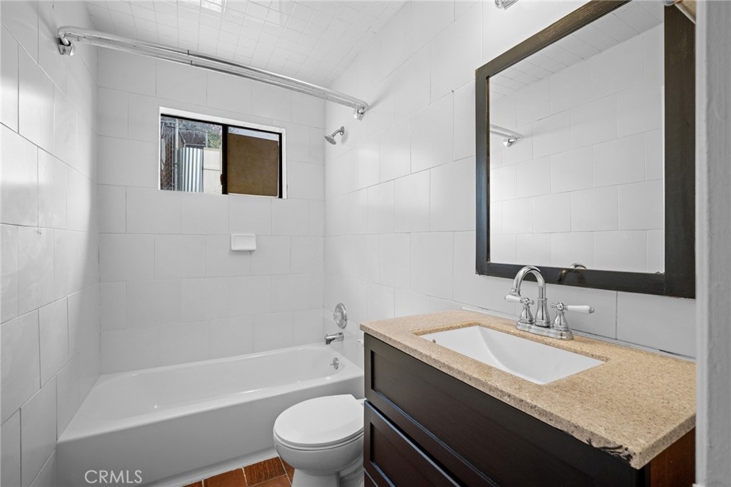 7025 Day Street Tujunga, CA 91042 - Photo 11 of 28 a bathroom with a granite countertop sink toilet and shower
