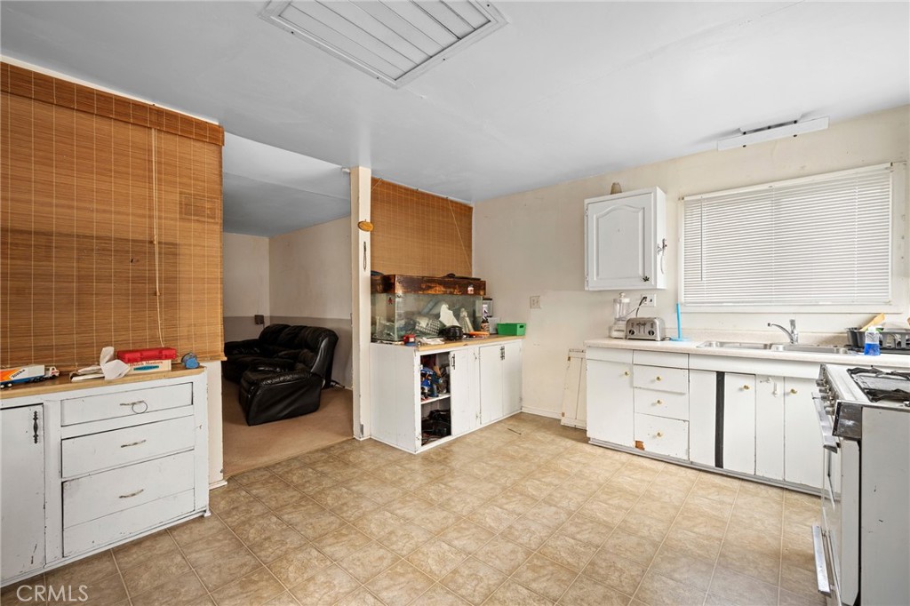 7025 Day Street Tujunga, CA 91042 - Photo 24 of 37 a kitchen with a stove a sink and a refrigerator