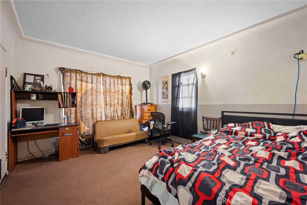 7025 Day Street Tujunga, CA 91042 - Photo 25 of 37 a bedroom with a bed and a couch