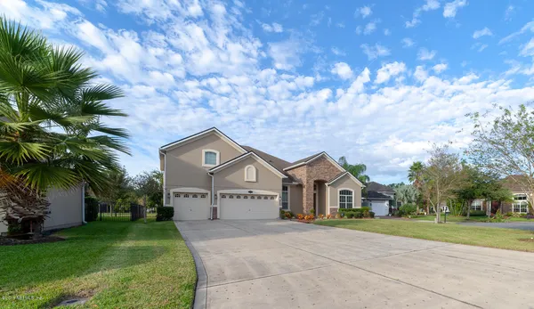 a front view of a house with a yard and garage