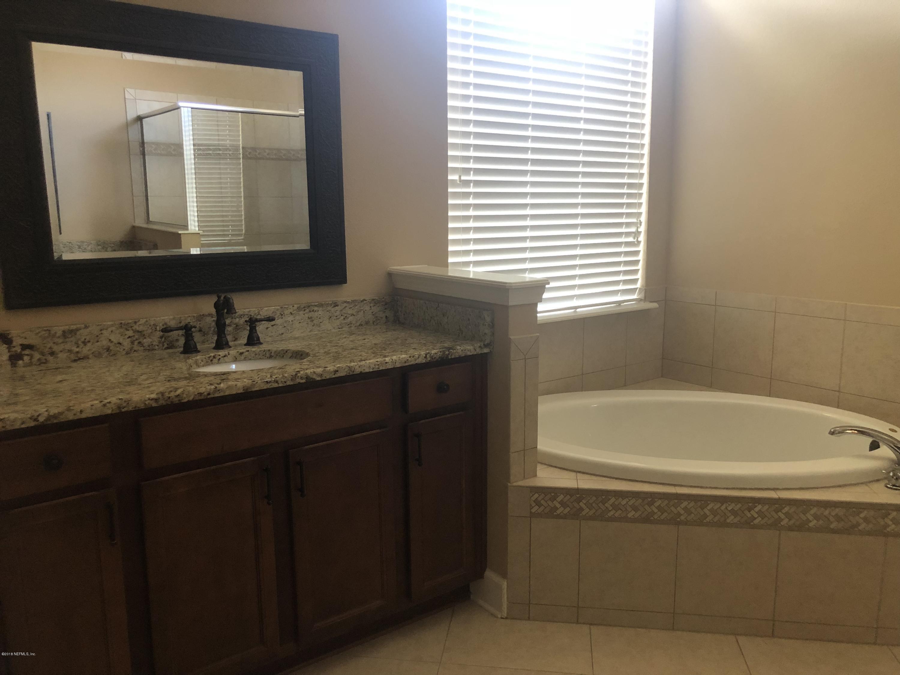 732 Castledale Court St. Johns, FL 32259 - Photo 15 of 51 a bathroom with a bathtub and a sink