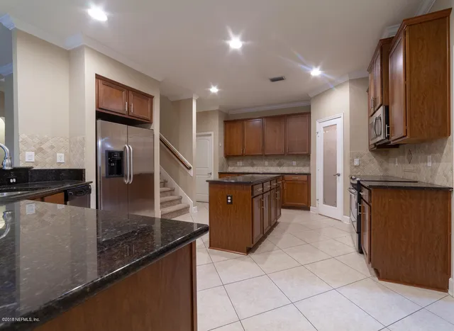 a stove top oven sitting inside of a kitchen