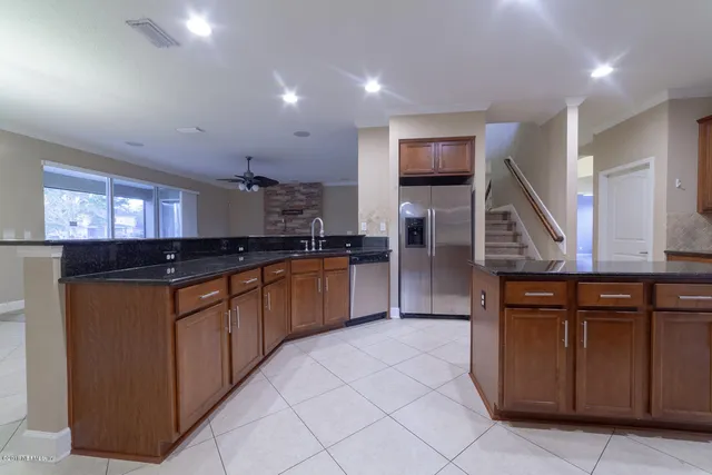 a utility room with cabinets washer and dryer