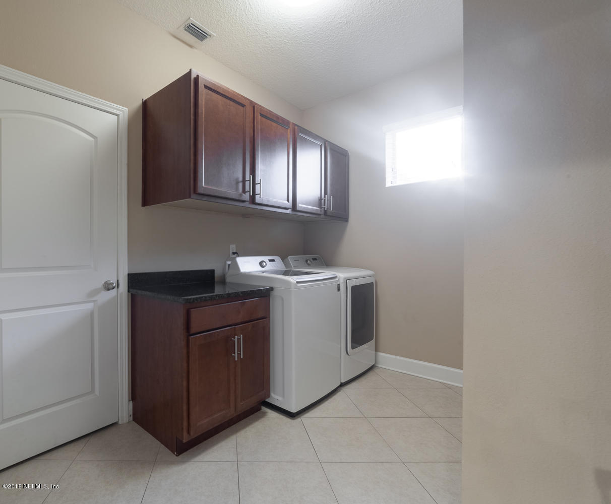 732 Castledale Court St. Johns, FL 32259 - Photo 25 of 51 a utility room with cabinets washer and dryer