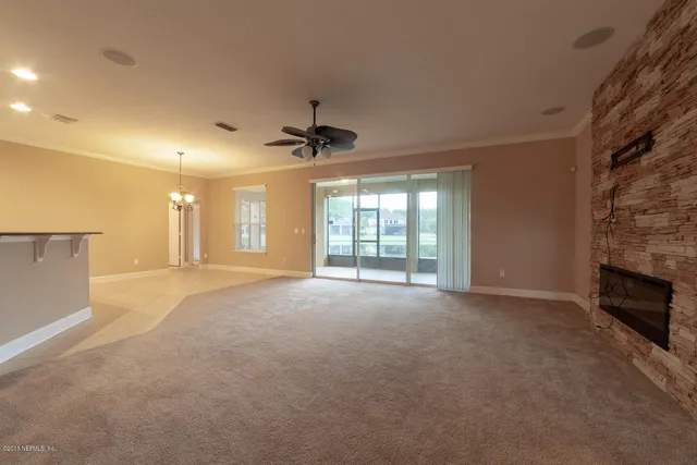 a view of a livingroom with a chandelier fan