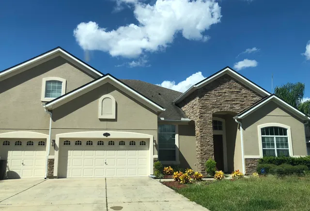 a front view of a house with a yard and garage