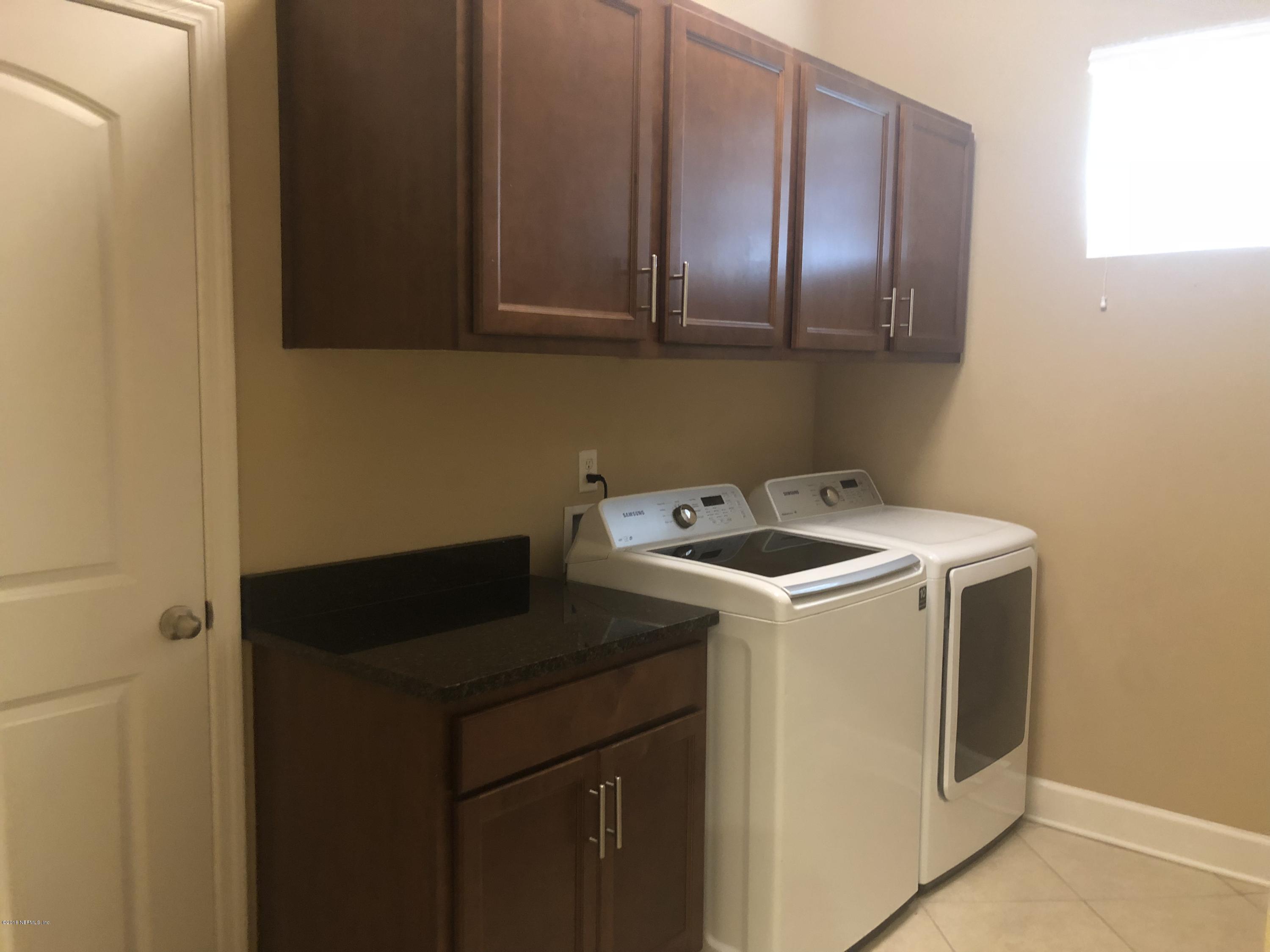 732 Castledale Court St. Johns, FL 32259 - Photo 8 of 51 a utility room with dryer and washer