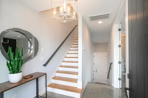 a view of entryway and hall with wooden floor