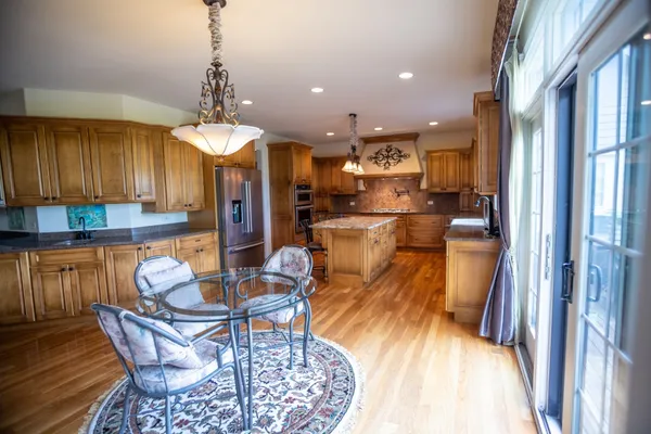 a dining room with furniture and a chandelier