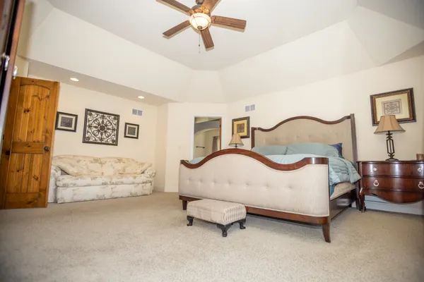 a bedroom with a bed and lamp