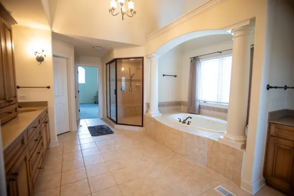 a spacious bathroom with a tub shower and sink