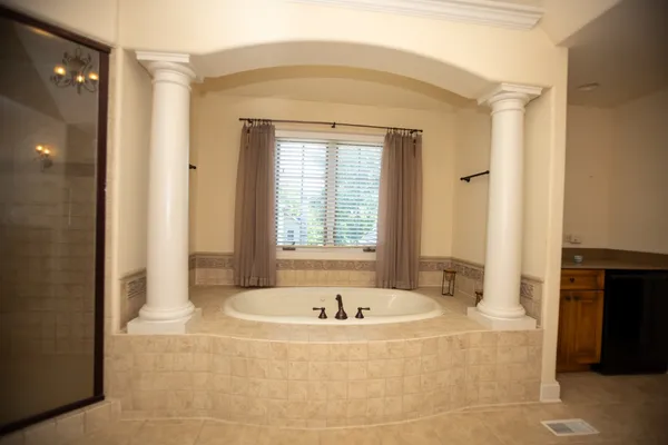 a bathroom with a tub and shower