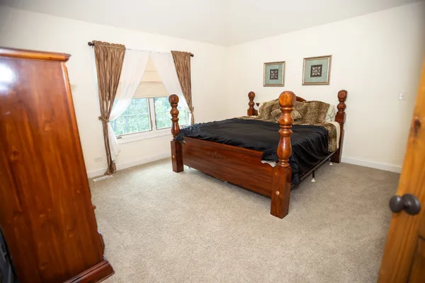 a bed room with a bed and a window