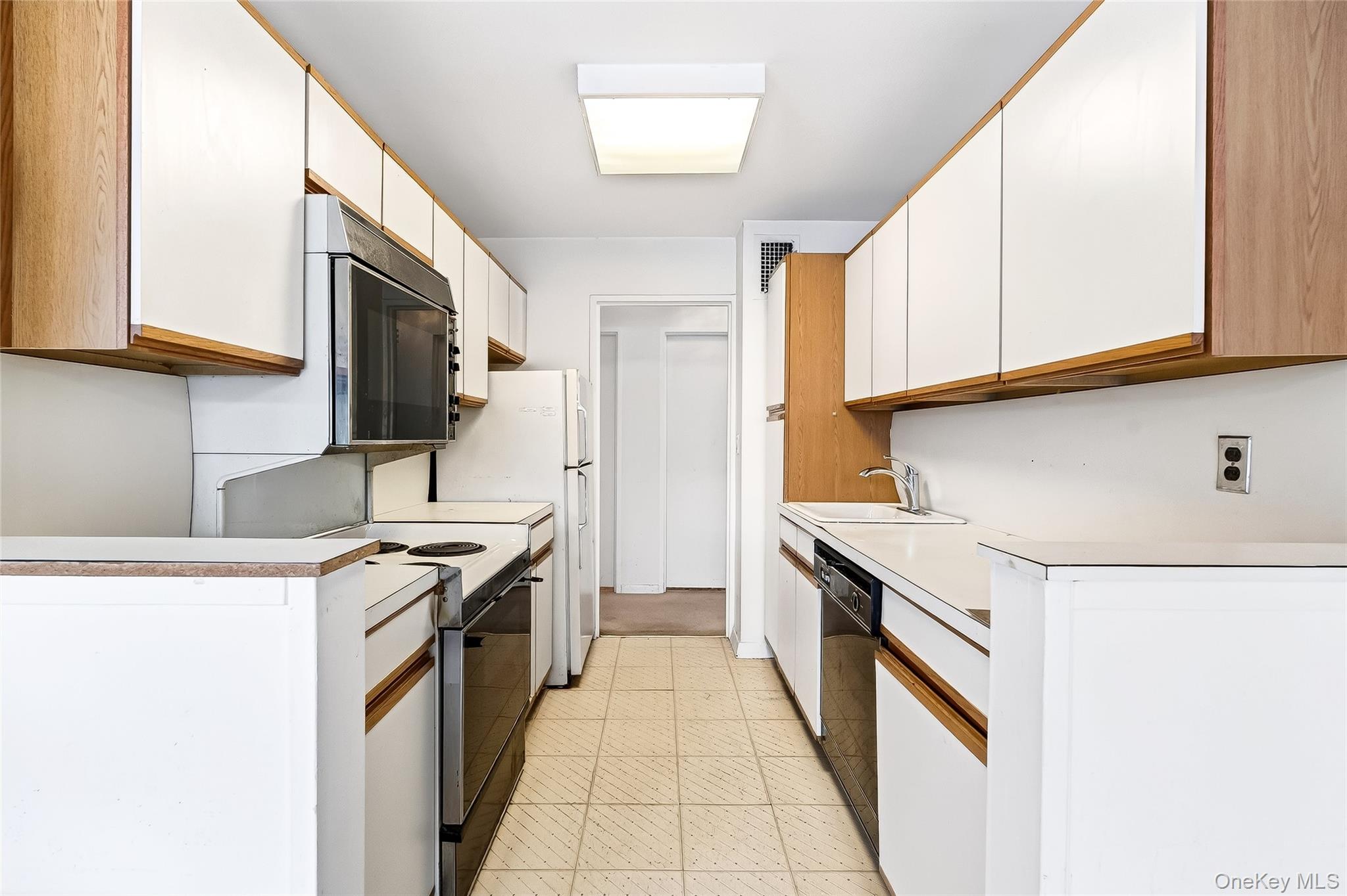 12 Old Mamaroneck Road, Unit 2G White Plains, NY 10605 - Photo 18 of 38 a kitchen with stainless steel appliances granite countertop a stove a sink and a microwave