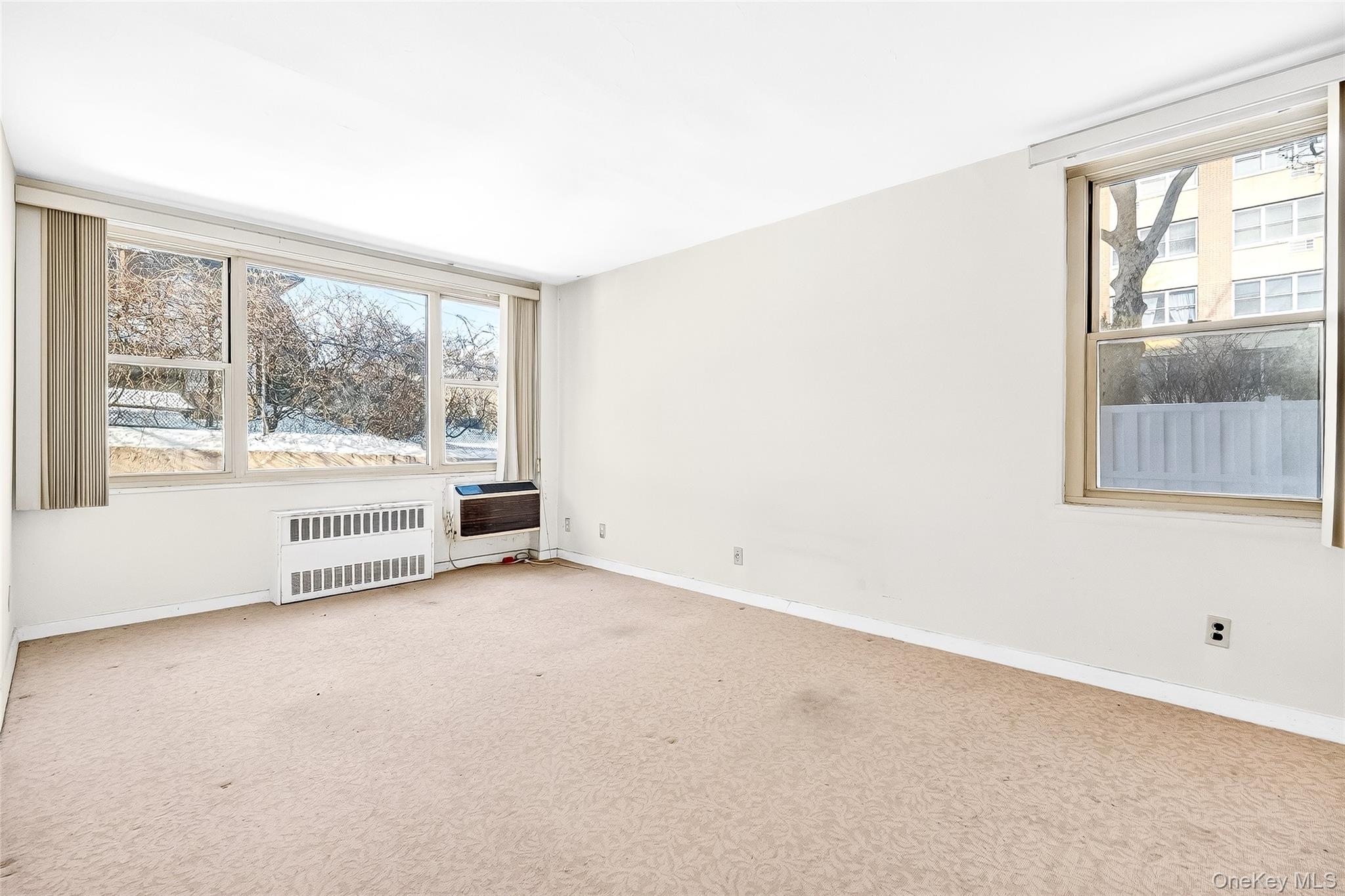 12 Old Mamaroneck Road, Unit 2G White Plains, NY 10605 - Photo 24 of 38 an empty room with large windows