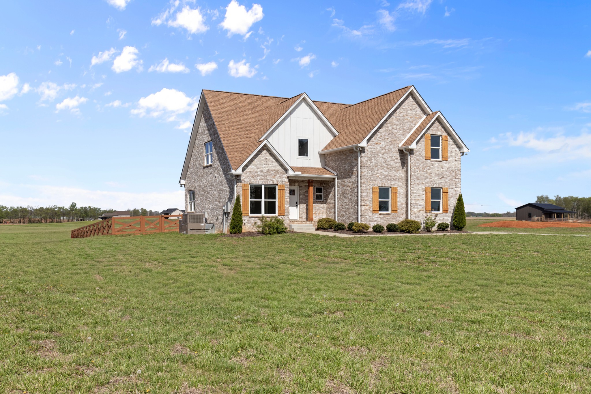 a view of a big house with a big yard and potted plants