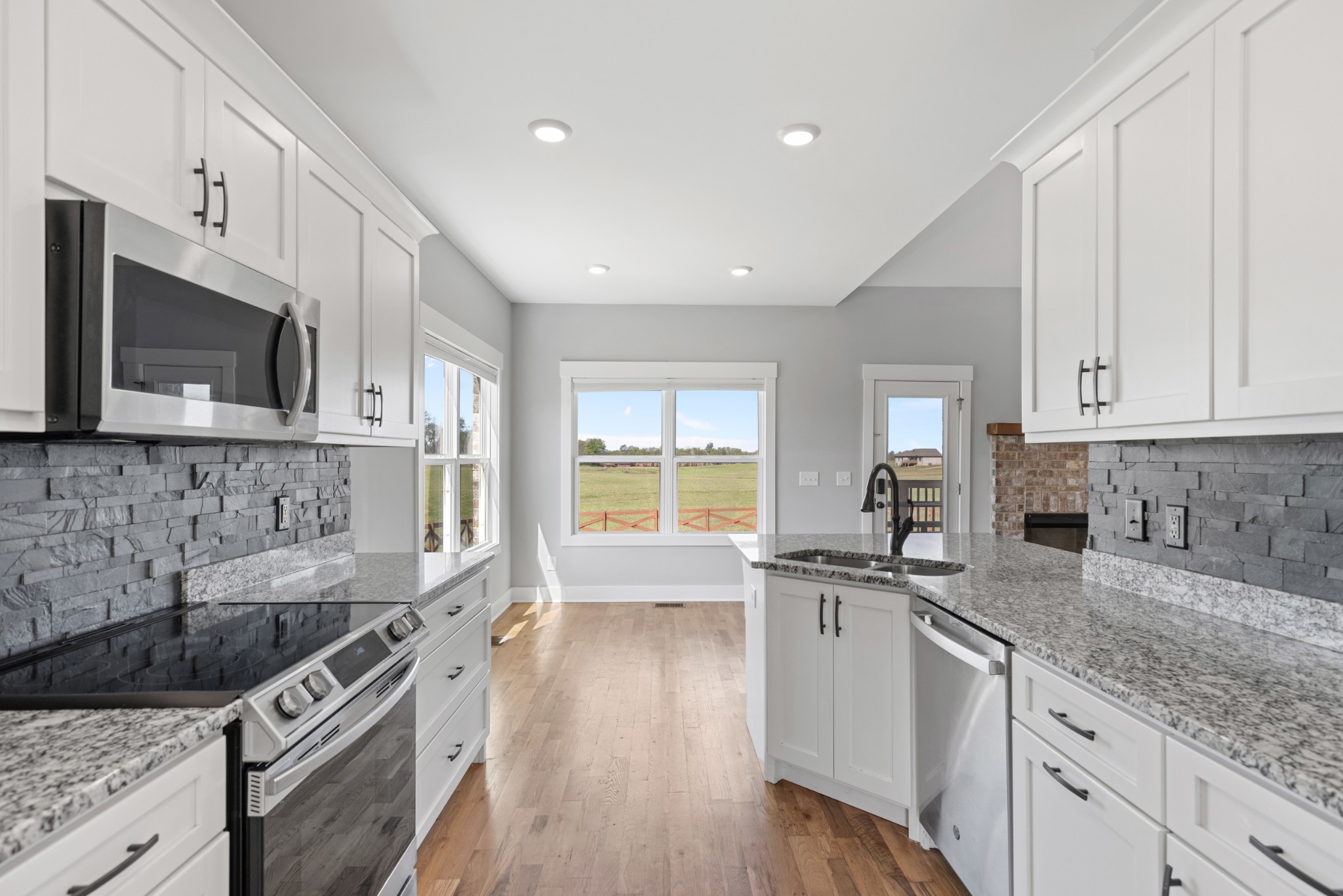 5450 Highway 431 Springfield, TN 37172 - Photo 21 of 54 a kitchen with stainless steel appliances granite countertop a sink stove and microwave