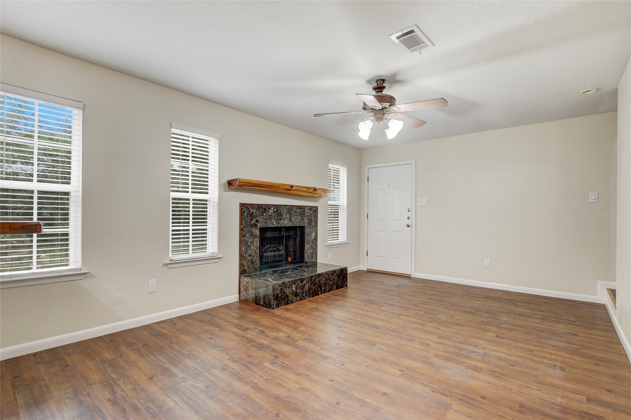 6902 Rifle Bend, Unit B Austin, TX 78736 - Photo 4 of 34 a view of empty room with wooden floor and fan