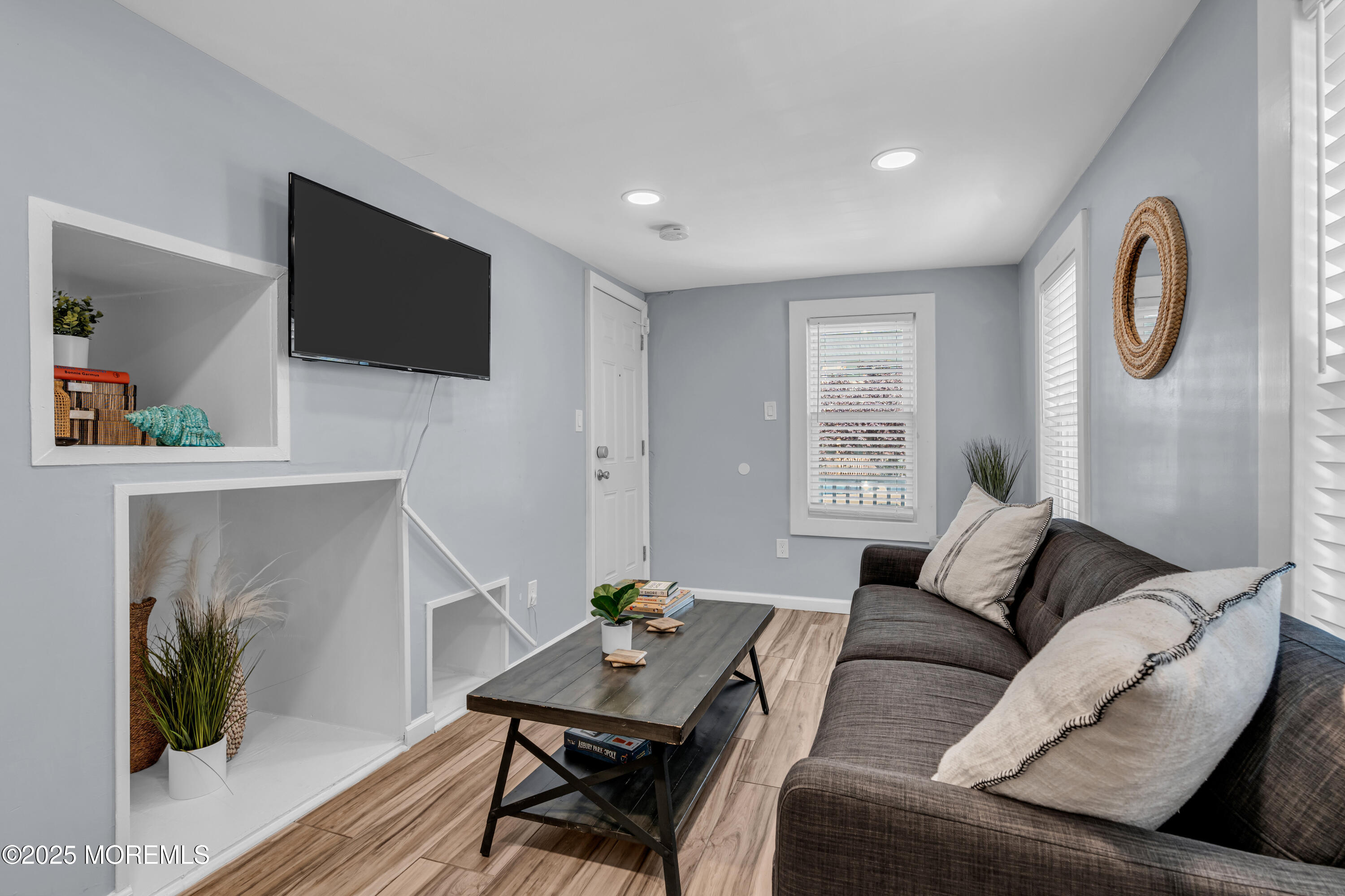 68 Clark Avenue, Unit 1E Ocean Grove, NJ 07756 - Photo 3 of 13 a living room with furniture and a flat screen tv