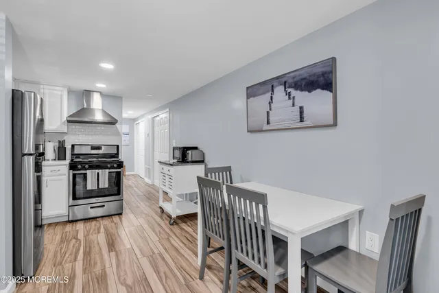a kitchen with stainless steel appliances a refrigerator and a stove top oven