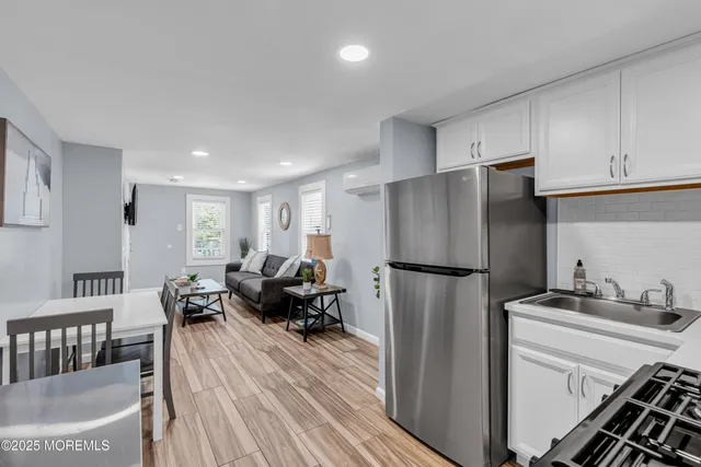 a kitchen with stainless steel appliances a refrigerator sink and cabinets