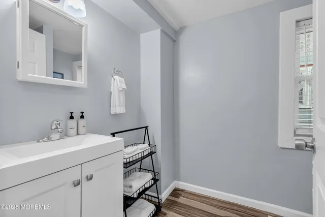 a bathroom with a sink vanity and a mirror