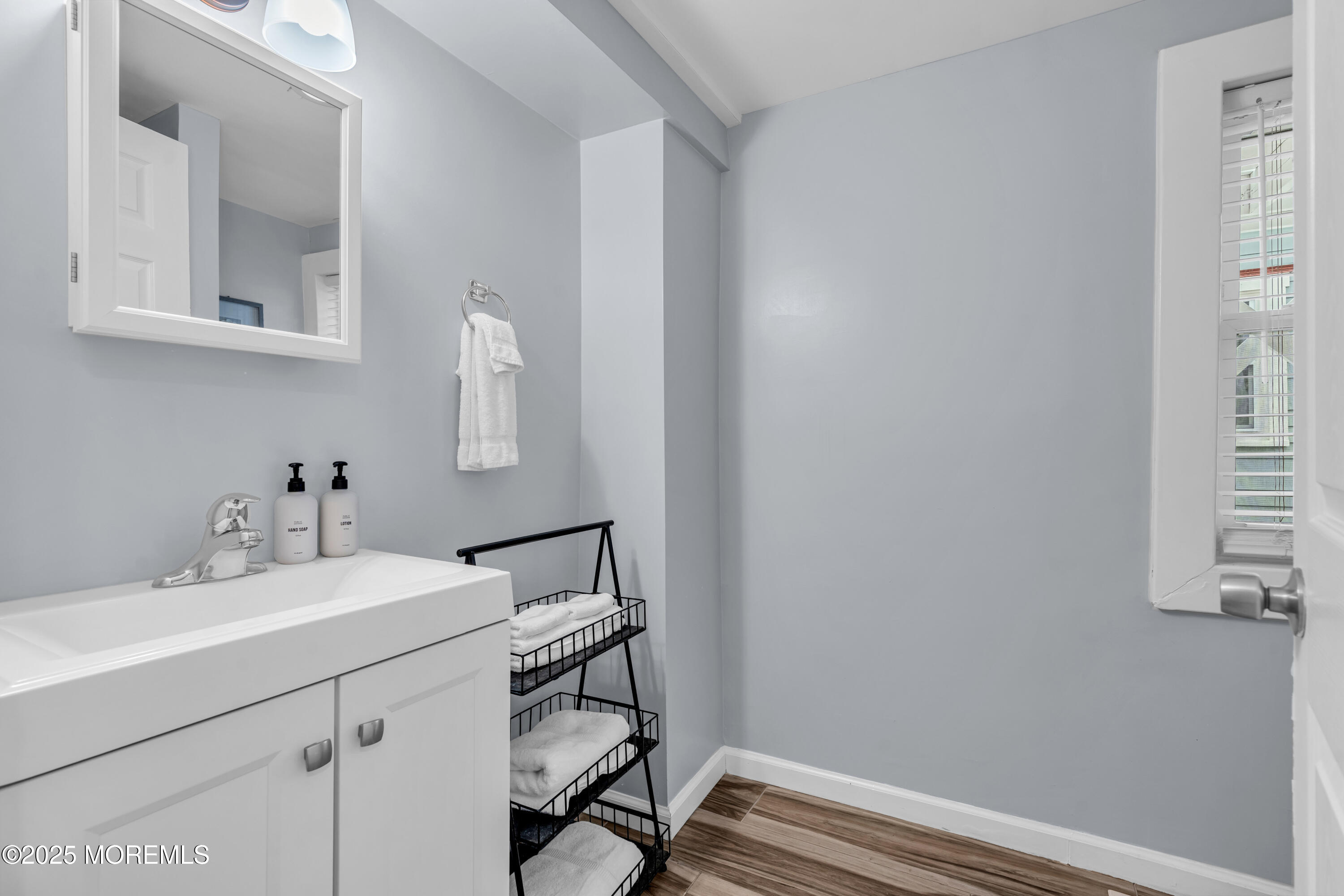 68 Clark Avenue, Unit 1E Ocean Grove, NJ 07756 - Photo 8 of 13 a bathroom with a sink vanity and a mirror