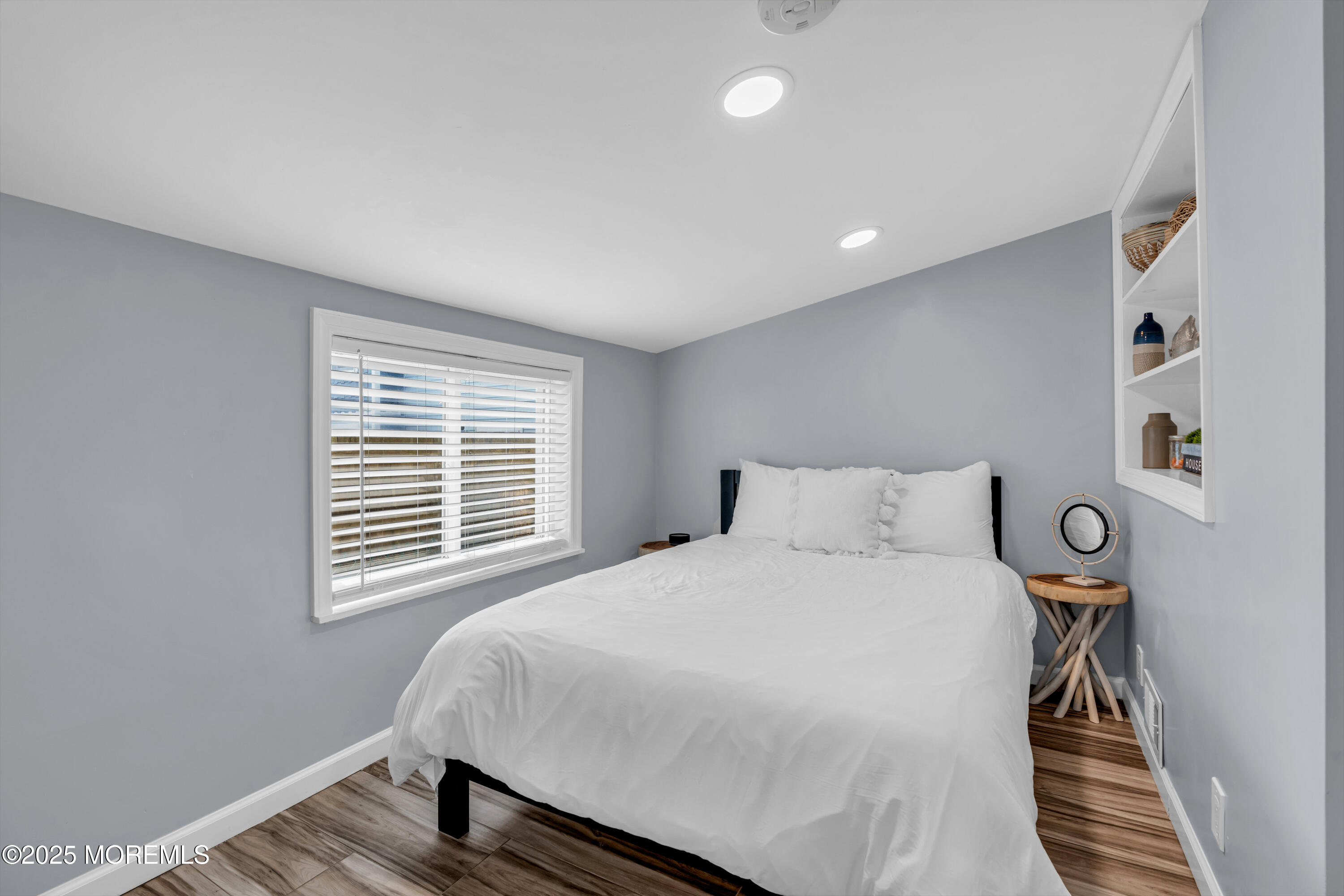 68 Clark Avenue, Unit 1E Ocean Grove, NJ 07756 - Photo 10 of 13 a bedroom with a bed and wooden floor