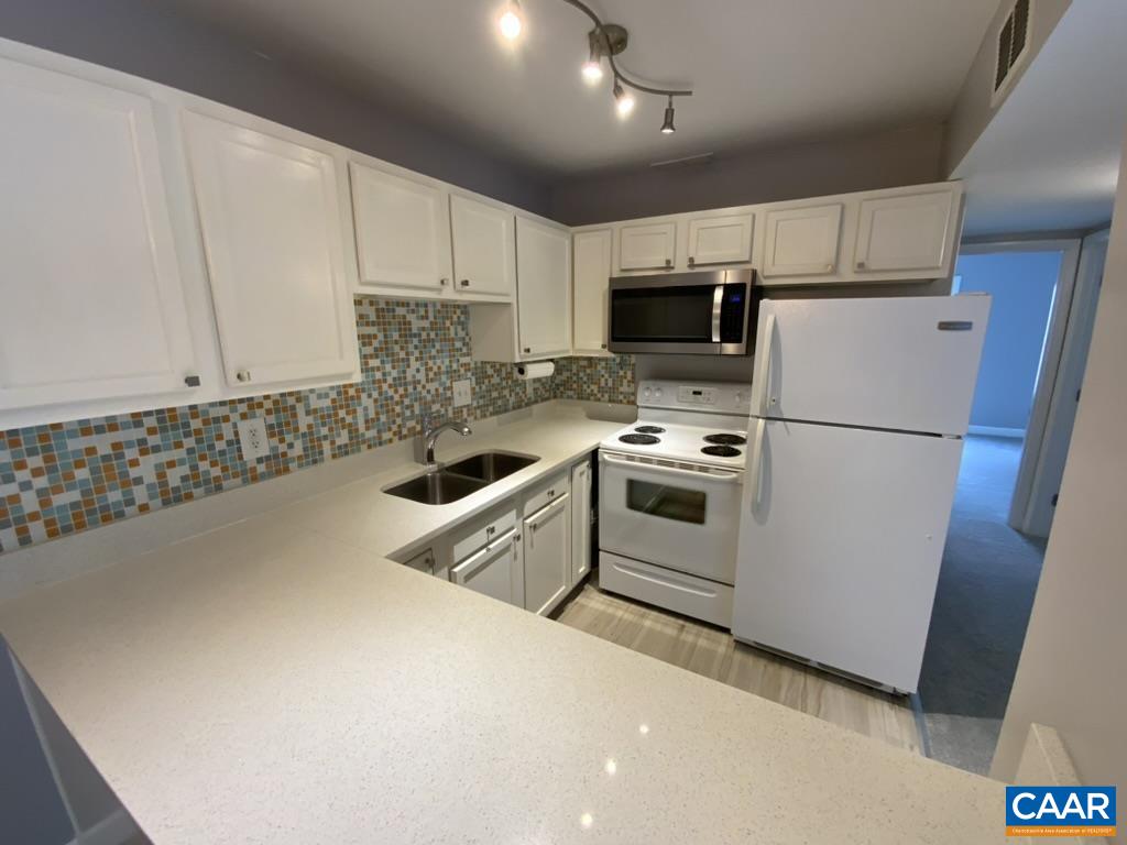 117 Berry Street, Unit 12 Orange, VA 22960 - Photo 1 of 10 a kitchen with stainless steel appliances a refrigerator sink and microwave