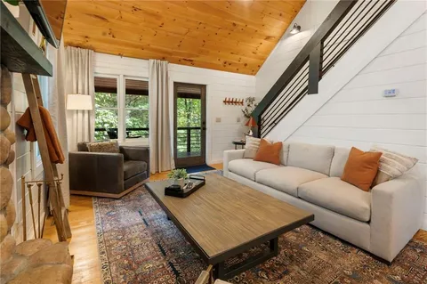 a view of a chairs and table in patio with wooden floor